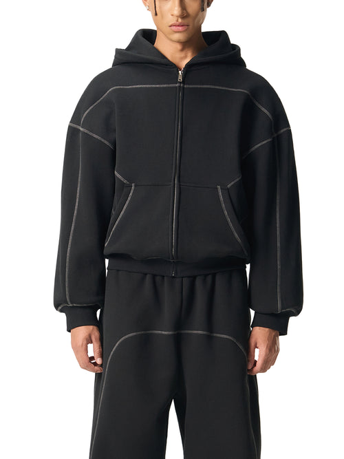 Black oversized zip-up hoodie with contrast stitching, paired with matching streetwear joggers for urban style
